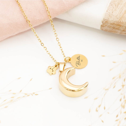 A Gold Personalised dog urn necklace self-fill style on a table