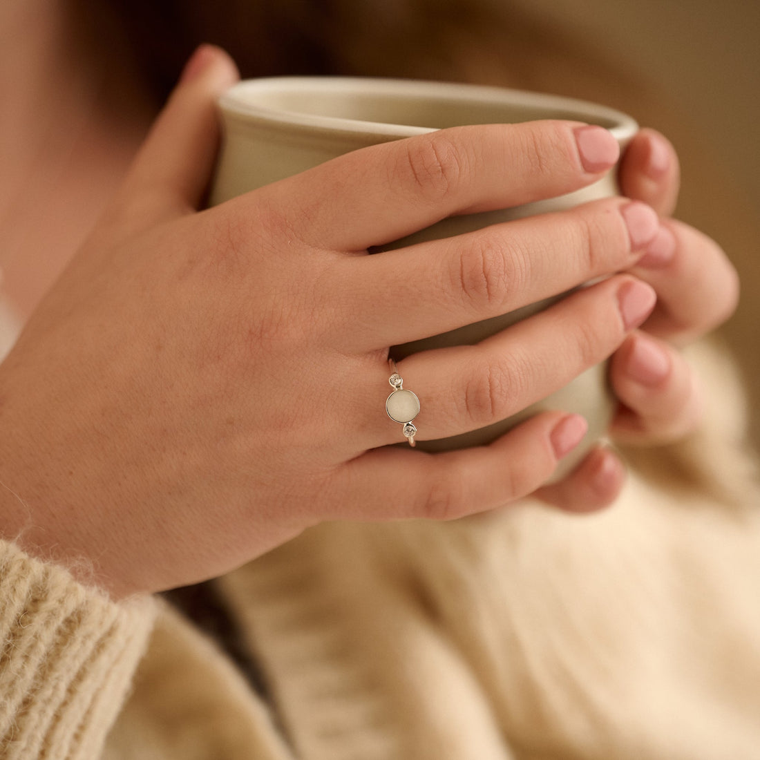 Cremation resin jewellery made from ashes. The memorial ring is being worn by a woman