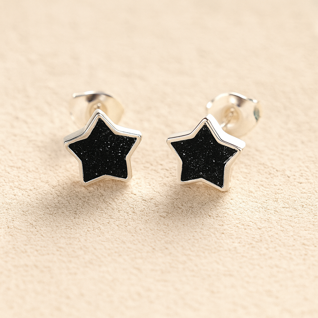 Silver Memorial Star-Shaped Ashes Earrings with black resin on a beige background