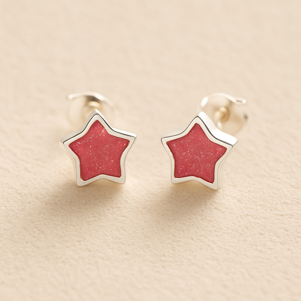 Silver Memorial Star-Shaped Ashes Earrings with dark pink resin on a beige background