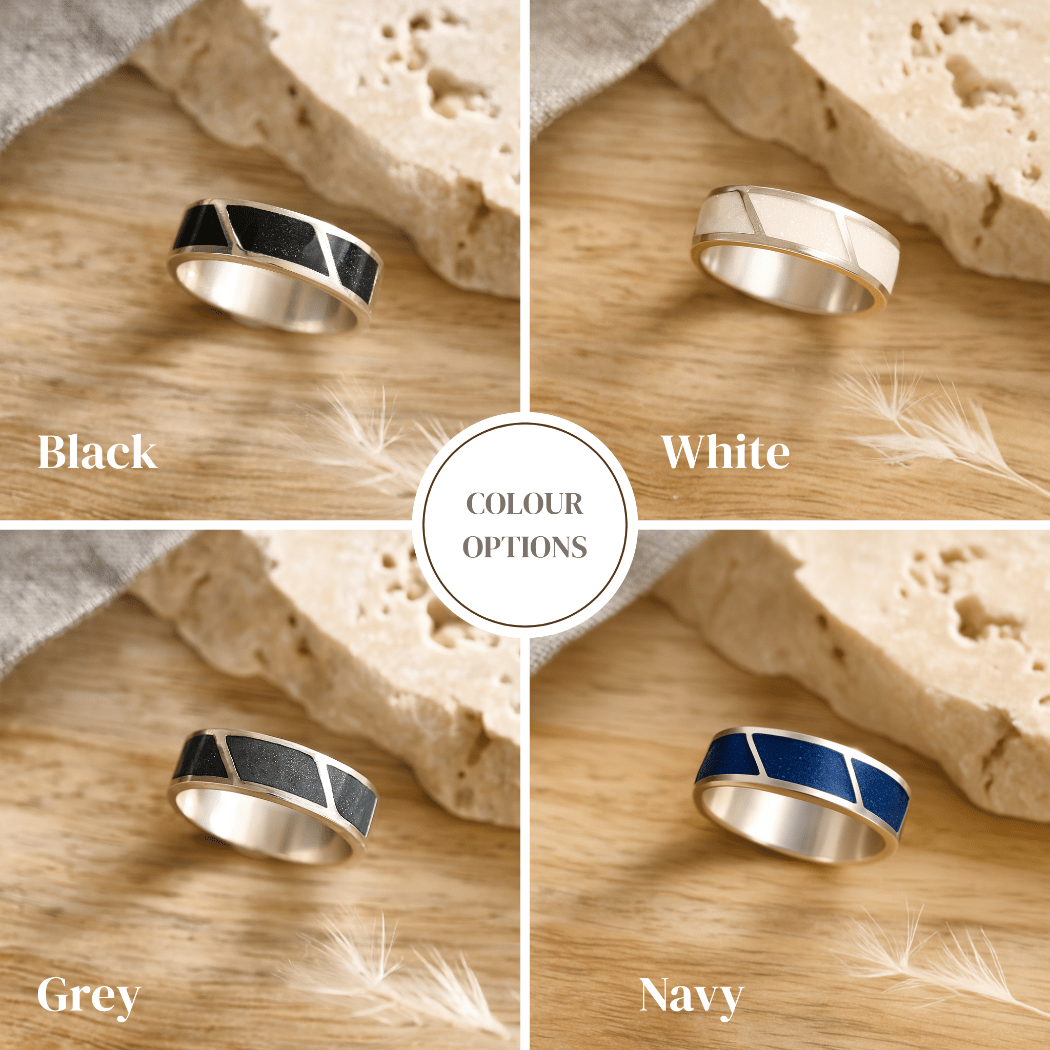 Four silver cremation rings for men in black, white, gray, and navy on a wooden surface with 'COLOUR OPTIONS' text.