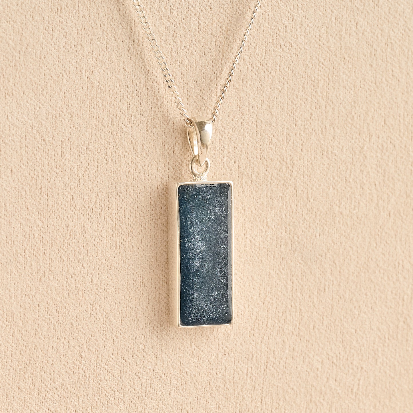 Men’s Cremation Ashes Rectangle Necklace with navy resin on a beige background