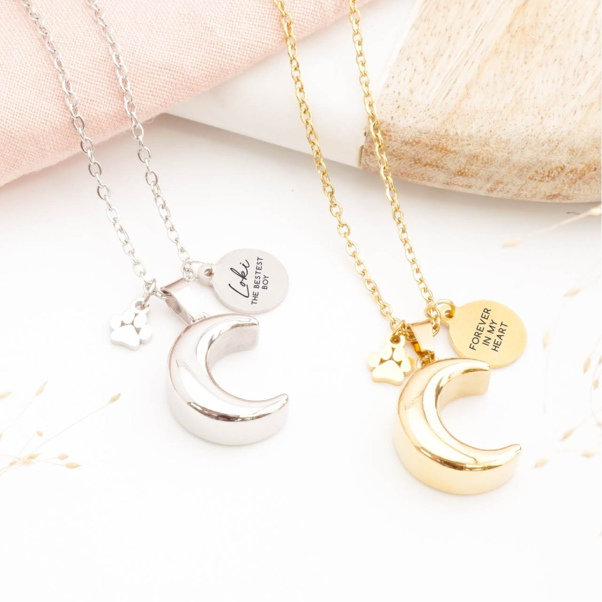 Gold and silver moon pet memorial necklace with engraved tags and paw print charms
