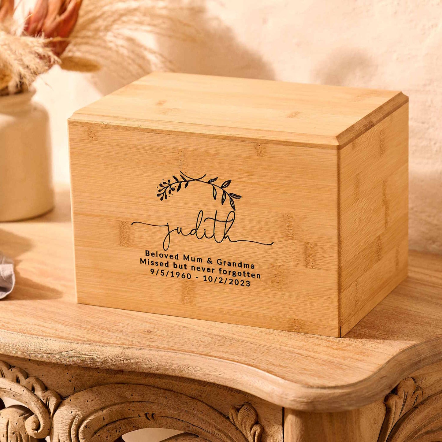 Handcrafted bamboo urn with custom laurel wreath design – sustainable ashes keepsake