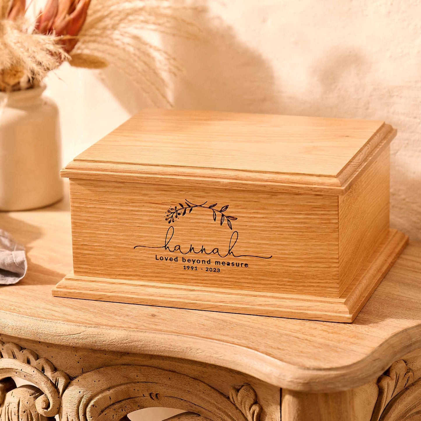 Handcrafted oak urn with custom laurel wreath design – wooden ashes keepsake