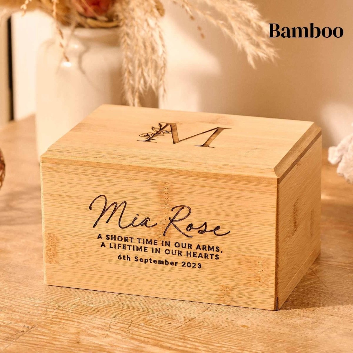 A cremation urn made of bamboo for a stillborn infant. Engraved urn.
