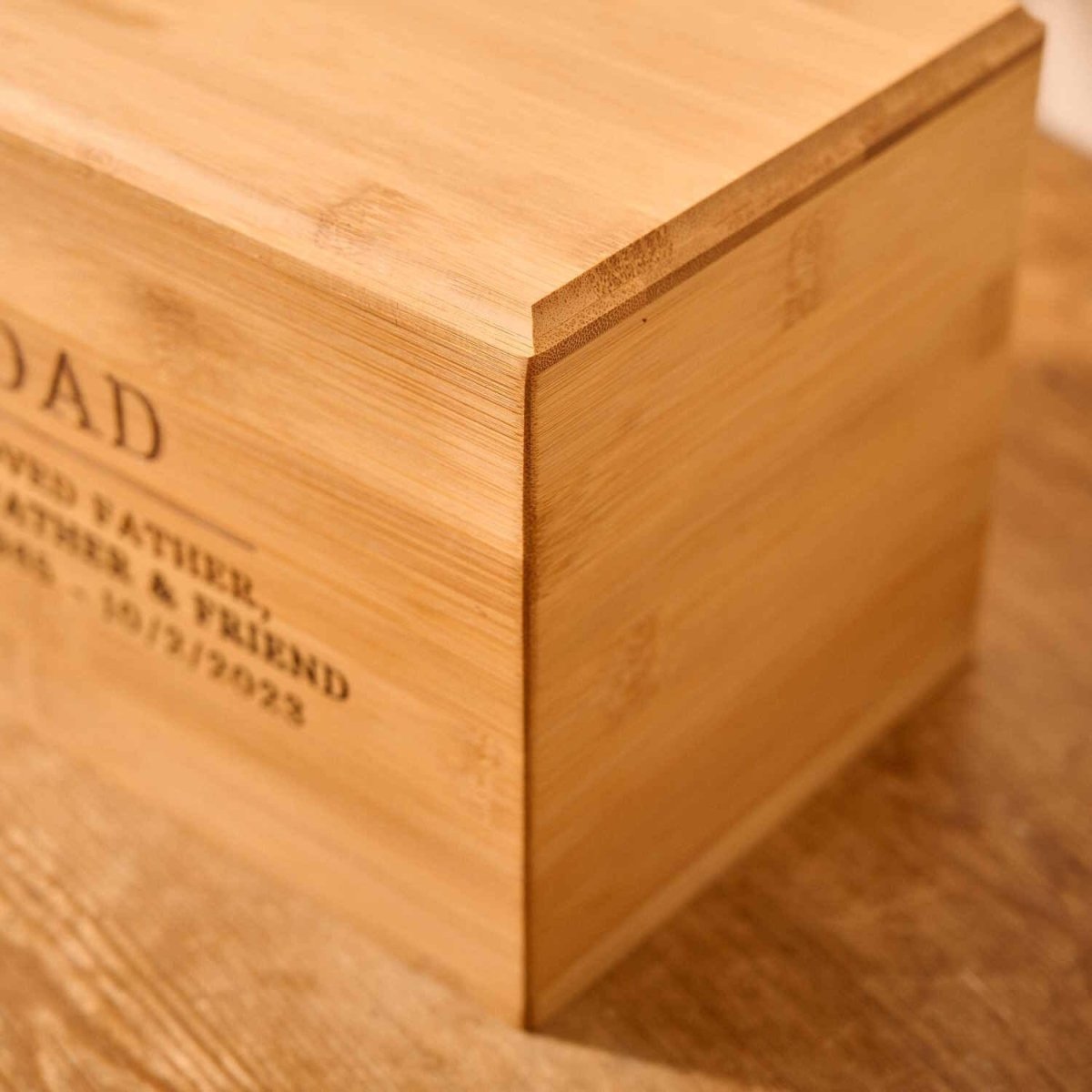 Close-up of custom engraved bamboo wood cremation urn – detailed view of solid wood memorial