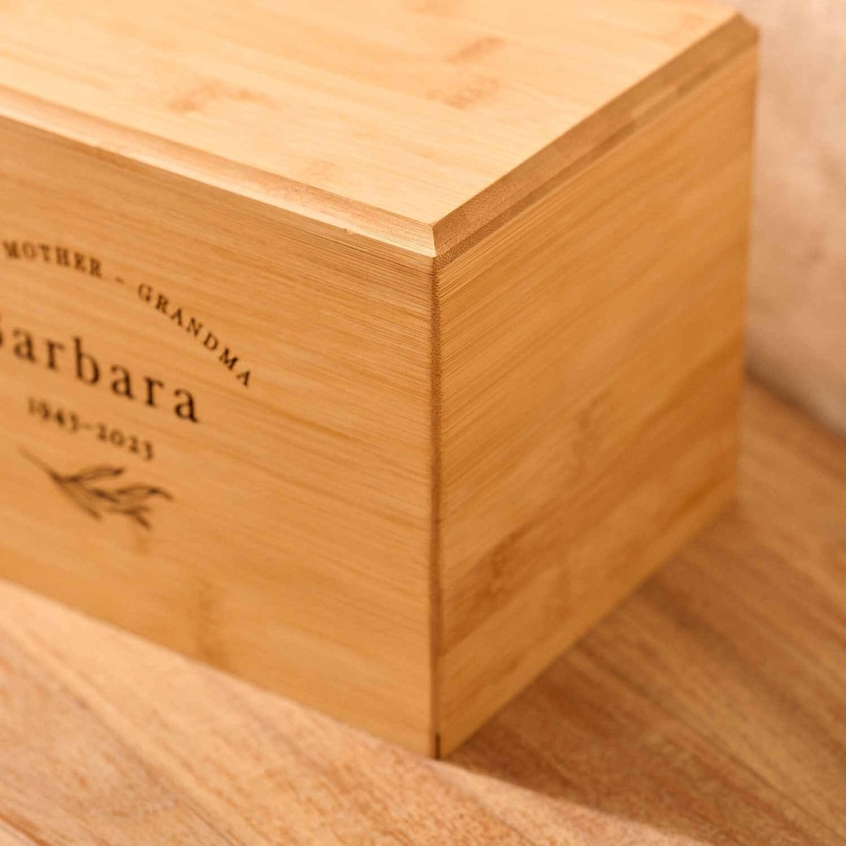 Close-up of engraved bamboo wood cremation urn – detailed view of solid wood memorial