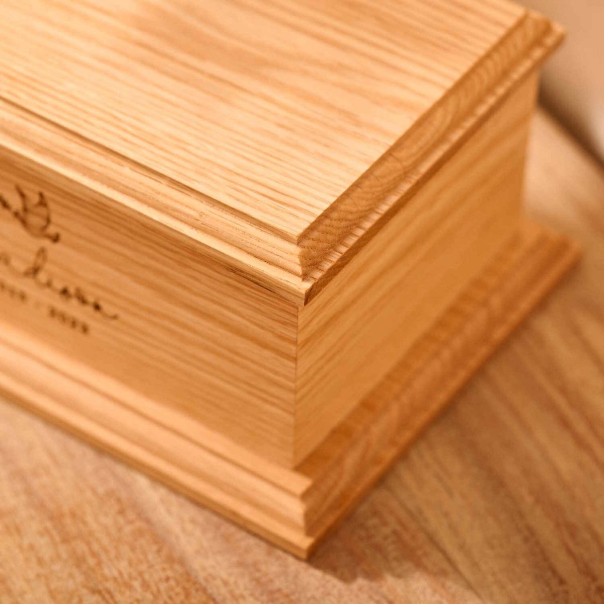 Detailed view of personalised oak wood child urn – custom engraved ashes urn