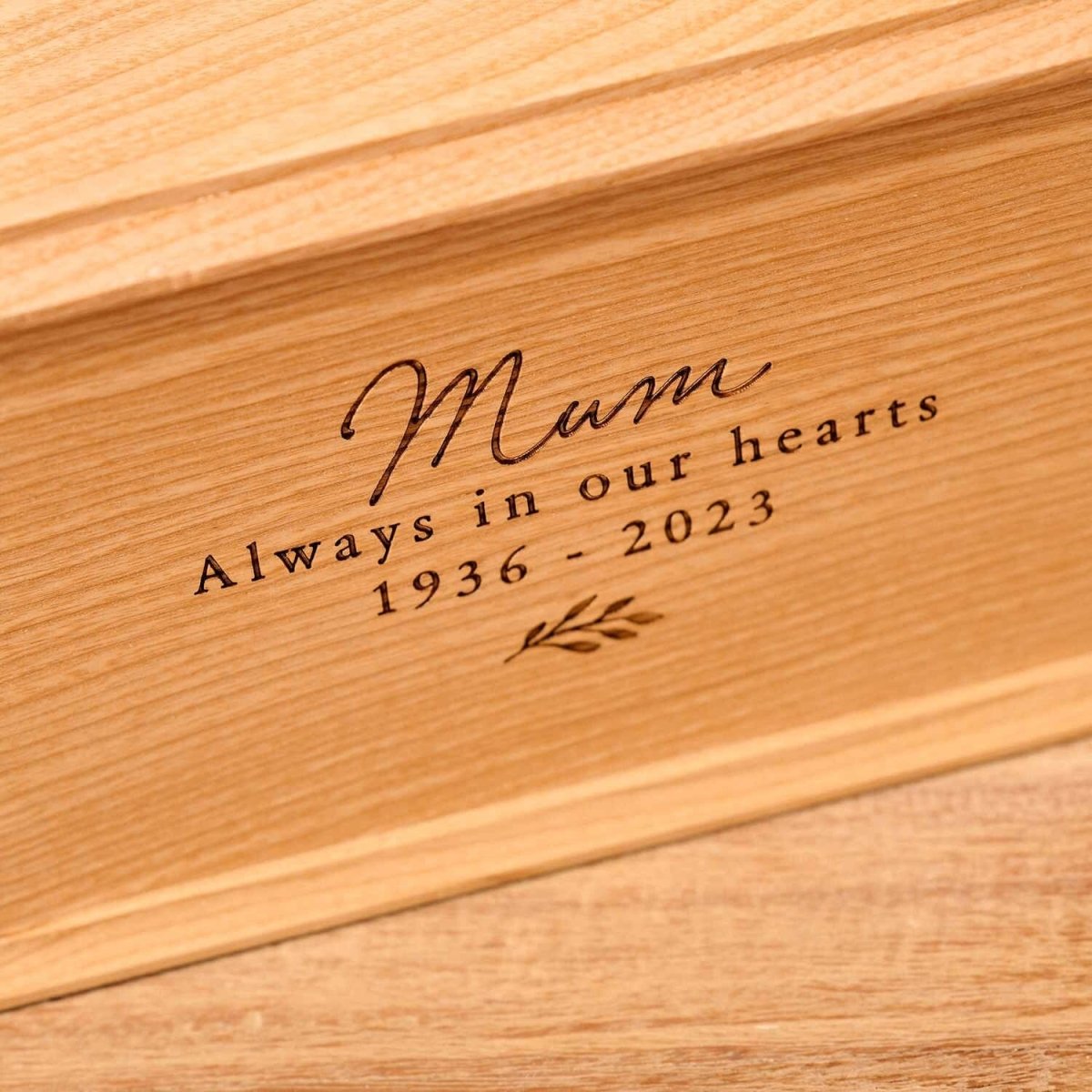 Detailed view of personalised ash wood urn with floral engraving for women – custom ashes urn