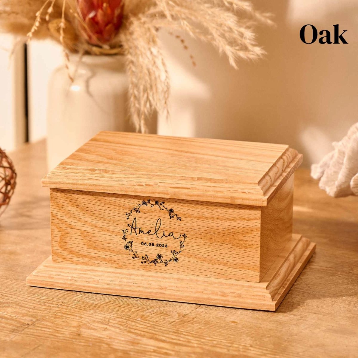 Personalised baby urn made from solid oak – engraved with name, floral wreath, and message for stillborn or miscarriage ashes.