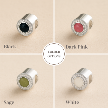 Four color options of a ashes bead with black, dark pink, sage, and white centers on a beige background.