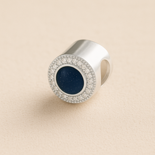 Silver Memorial Ashes Circle CZ Cremation Charm with Navy resin on a beige background