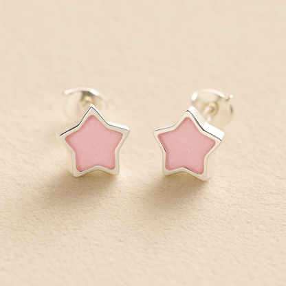 Silver Memorial Star-Shaped Ashes Earrings with light pink resin on a beige background