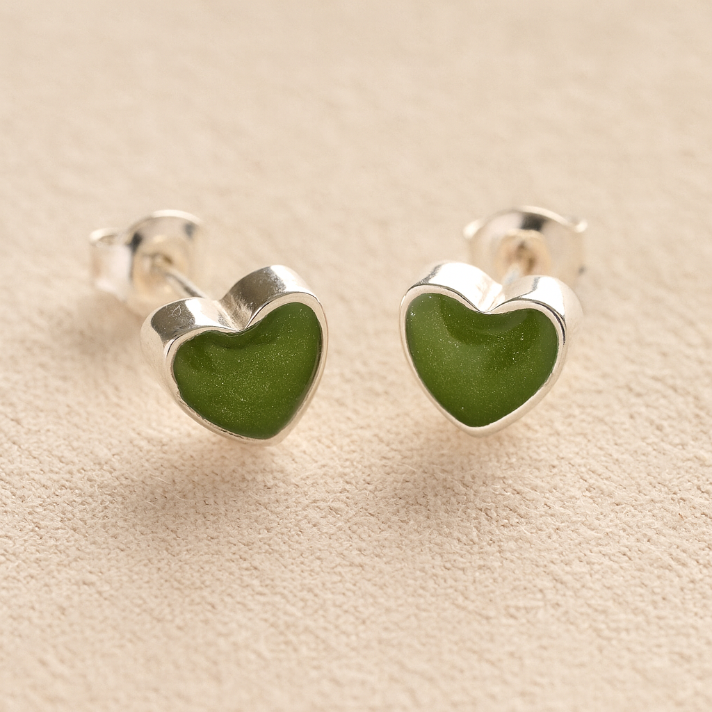 Silver Heart memorial earrings with sage resin with cremation ashes or fur a beige fabric background