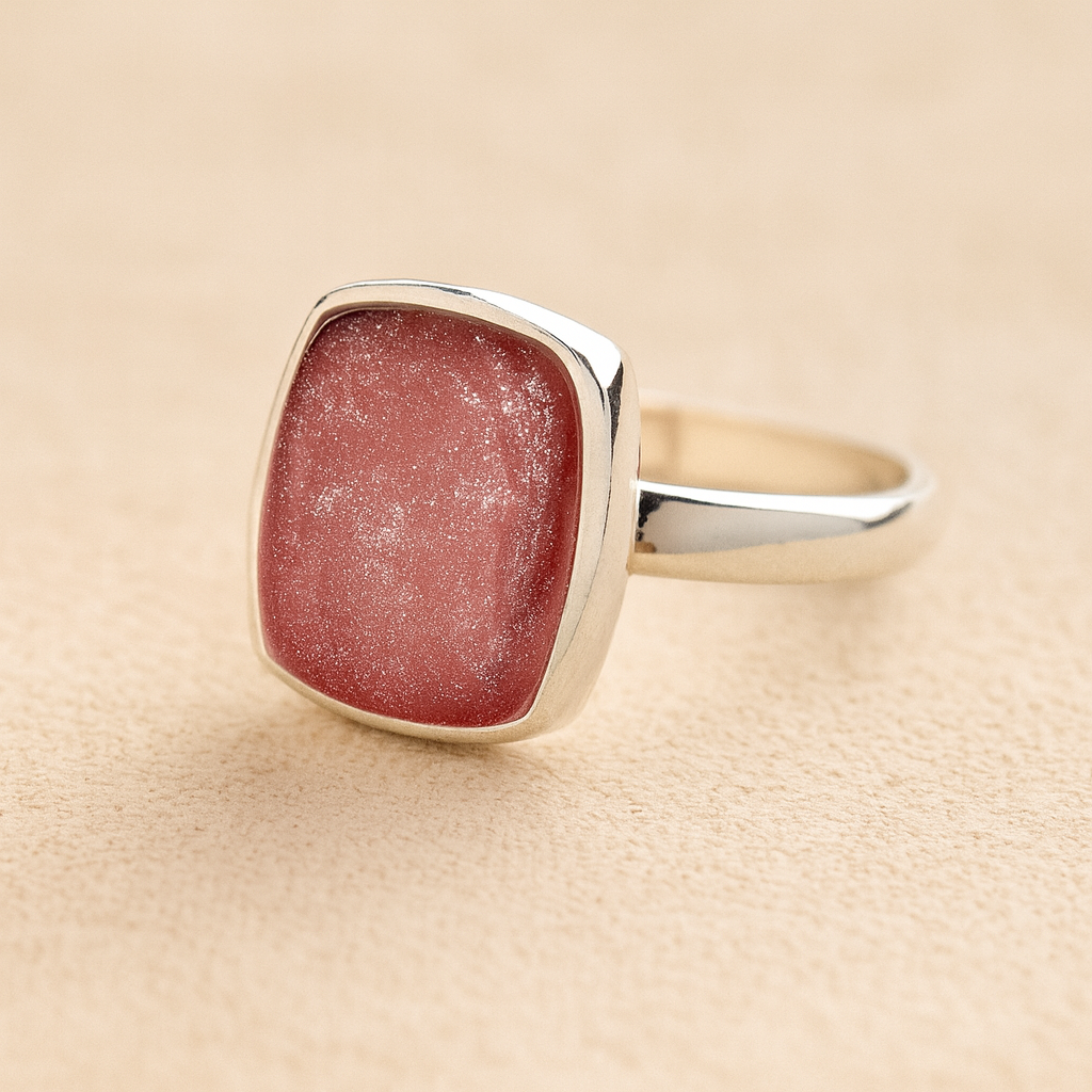 Silver Square Memorial Ashes Cremation Ring with dark pink resin, filled with ashes or fur, displayed on a soft beige background – suitable for pet or human memorials.