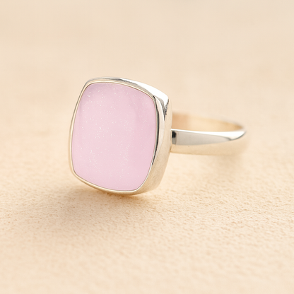 Silver Square Memorial Ashes Cremation Ring with light pink resin, filled with ashes or fur, displayed on a soft beige background – suitable for pet or human memorials.