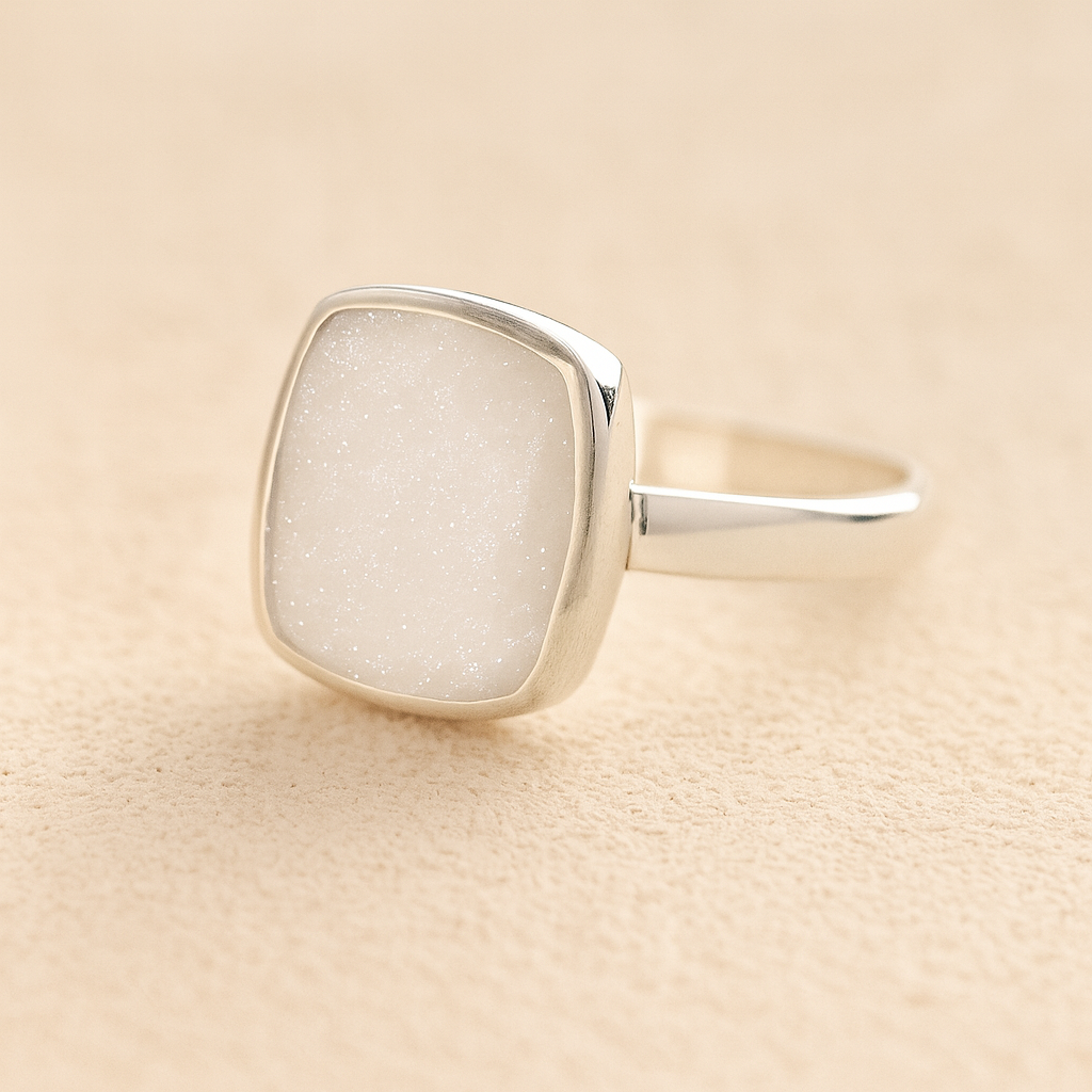 Silver Square Memorial Ashes Cremation Ring with white resin, filled with ashes or fur, displayed on a soft beige background – suitable for pet or human memorials.