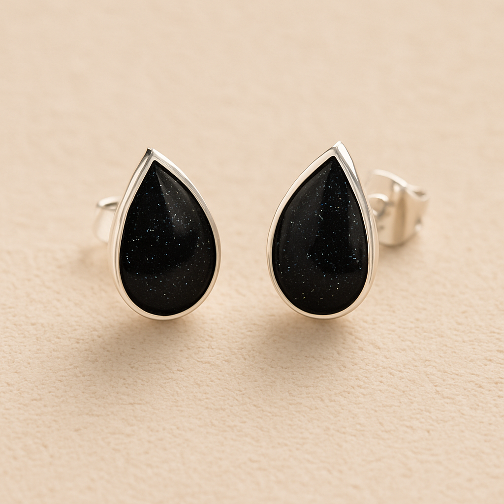 Silver Memorial Ashes Teardrop Stud Earrings with black resin on a beige background 