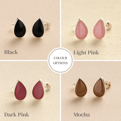 Teardrop-shaped Memorial earrings in black, light pink, dark pink, and mocha colors on a beige background.
