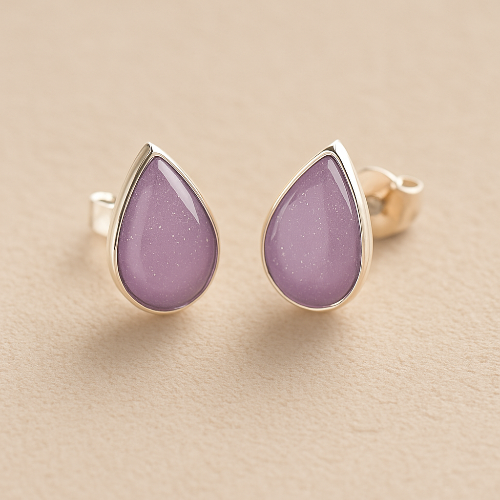 Cremation Ashes Teardrop Earrings with lavender resin on a beige background