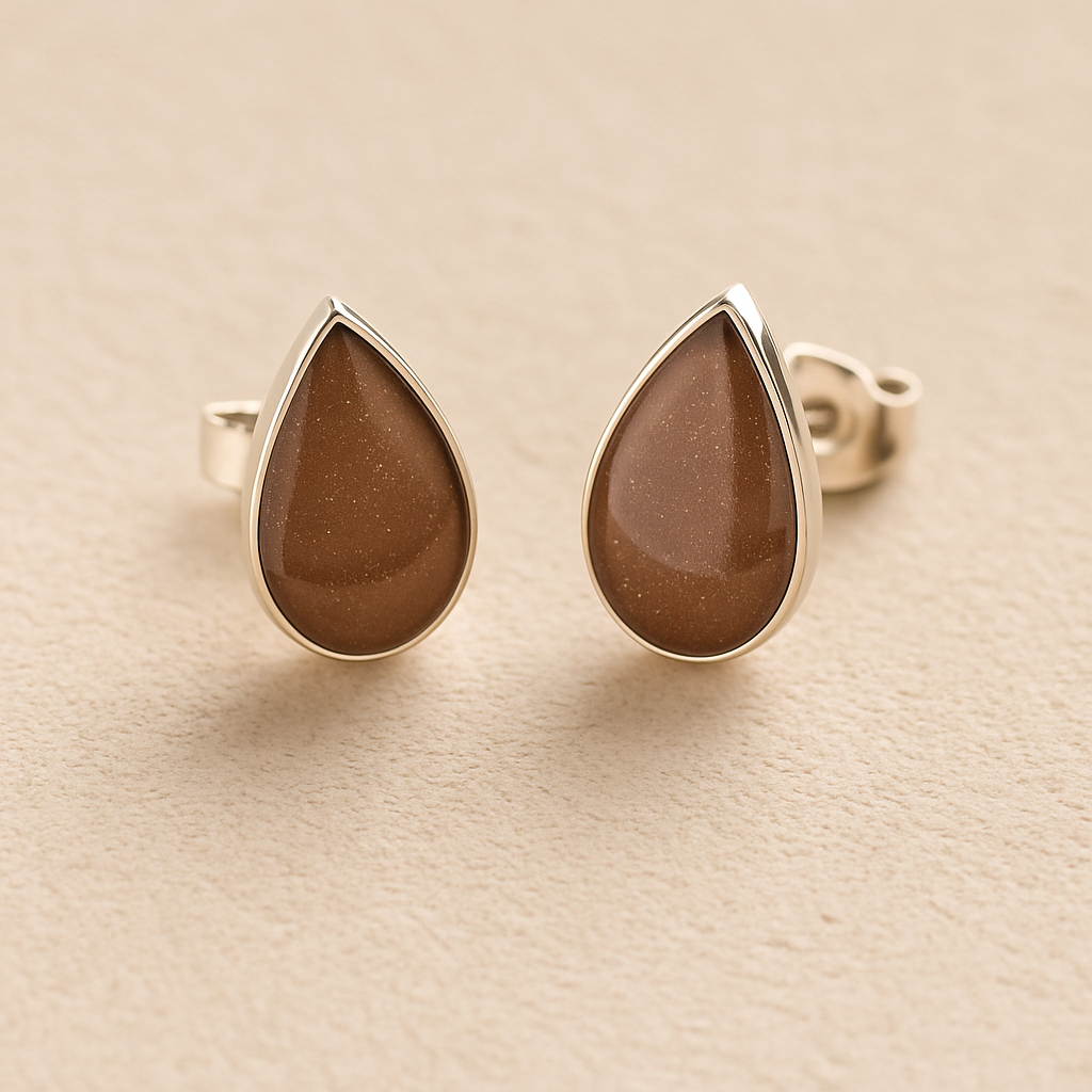 Silver Cremation Ashes Teardrop Earrings with mocha brown resin on a beige background