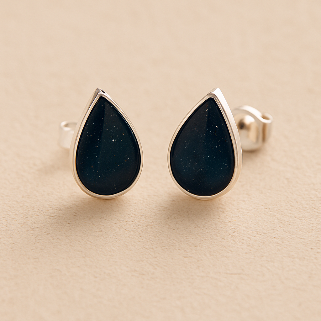 Silver teardrop memorial Ashes Earrings with navy resin on a beige background