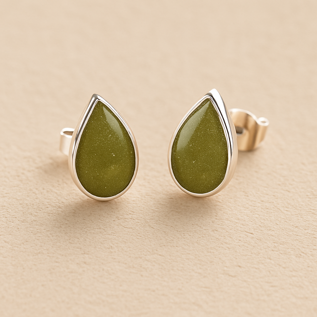 Silver Memorial Ashes Teardrop Earrings with sage green resin on a beige background