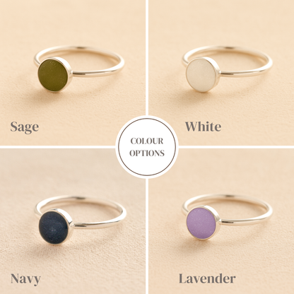 Four silver rings with colored stones on a beige background, labeled Sage, White, Navy, and Lavender.
