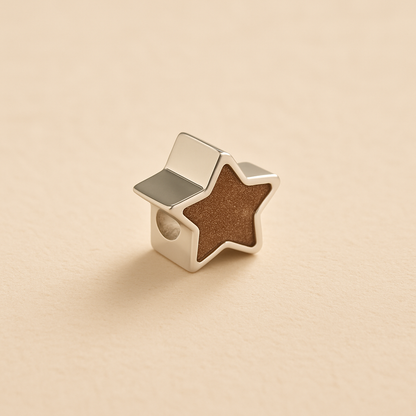 Silver star-shaped ashes Charm Bead with mocha resin on a beige background