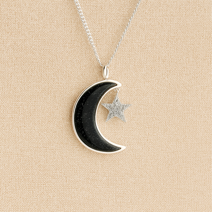 Moon and Star Memorial Necklace with black resin filled with ashes or fur on a beige textured background