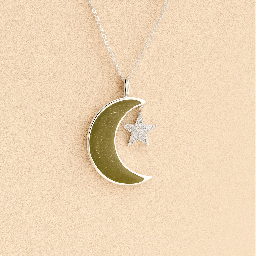 Moon and Star Memorial Necklace with sage resin filled with ashes or fur on a beige textured background