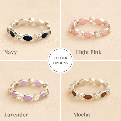 Silver cremation ashes ring with colour examples of resin and crystal accents, filled with ashes or fur, displayed on a soft beige background – suitable for pet or human memorials.