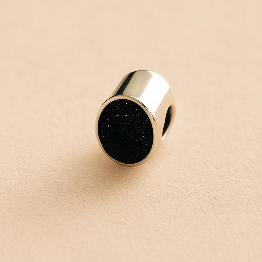 Silver Oval memorial ashes bead with a black resin infill designed to hold cremation ashes and pet fur. Memorial keepsake for pet loss