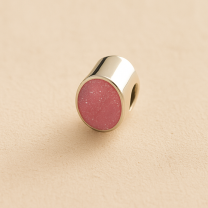 Silver Oval memorial ashes bead with a dark pink resin infill designed to hold cremation ashes and pet fur. Memorial keepsake for pet loss