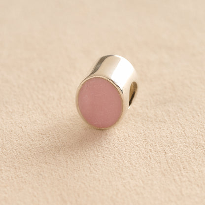 Silver Oval memorial ashes bead with a light pink resin infill designed to hold cremation ashes and pet fur. Memorial keepsake for pet loss