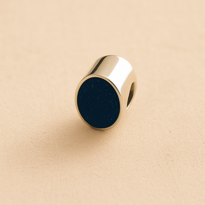 Silver Oval memorial ashes bead with a navy resin infill designed to hold cremation ashes and pet fur. Memorial keepsake for pet loss