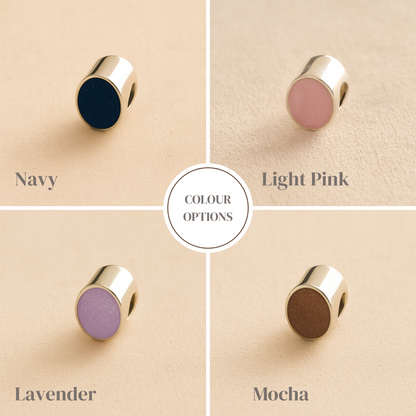 Jewelry memorial charm color options displayed on a beige background