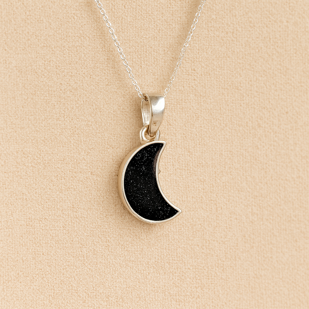 Silver Moon memorial Necklace with black resin, filled with ashes or fur, displayed on a soft beige background – suitable for pet or human memorials.