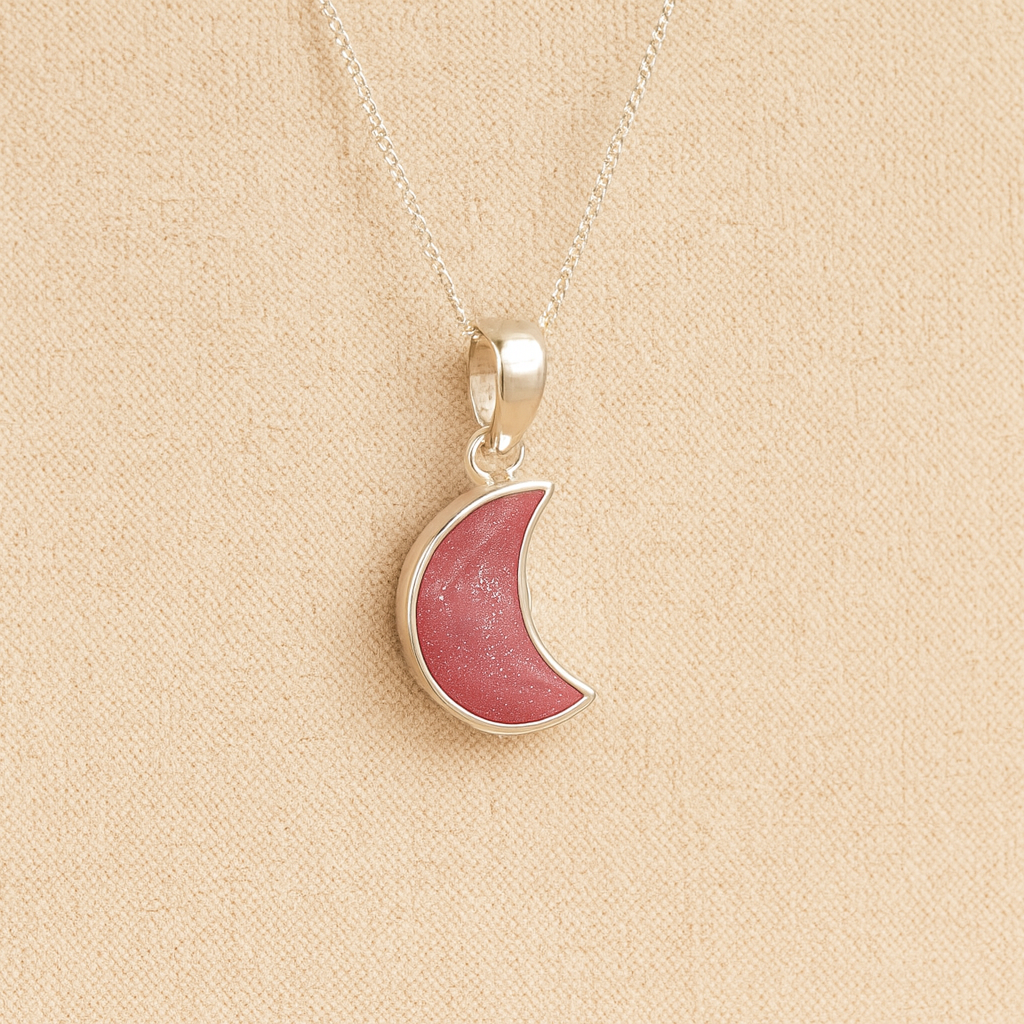 Silver Moon memorial Necklace with dark pink resin, filled with ashes or fur, displayed on a soft beige background – suitable for pet or human memorials.