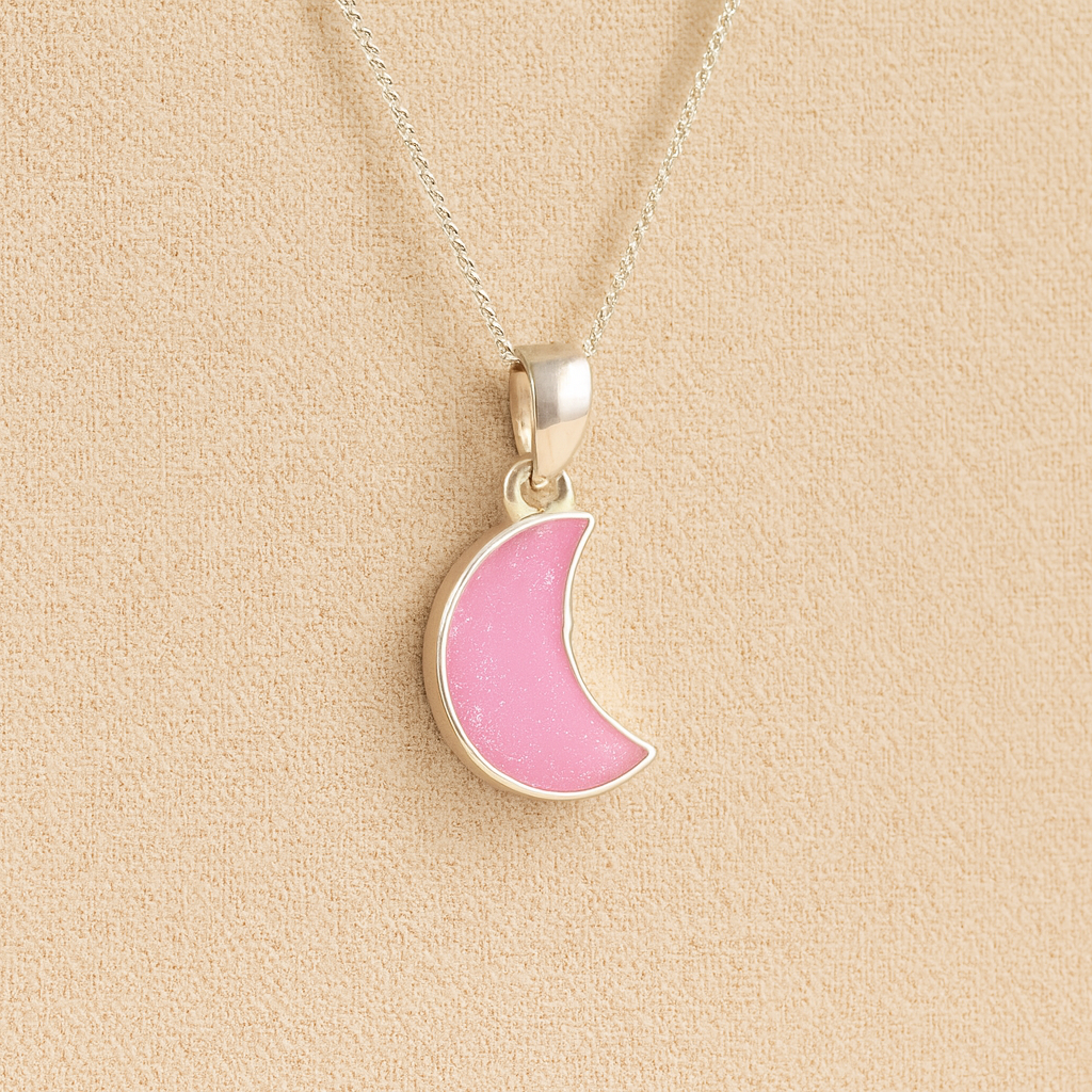 Silver Moon memorial Necklace with Light pink resin, filled with ashes or fur, displayed on a soft beige background – suitable for pet or human memorials.