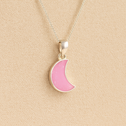 Silver Moon memorial Necklace with Light pink resin, filled with ashes or fur, displayed on a soft beige background – suitable for pet or human memorials.