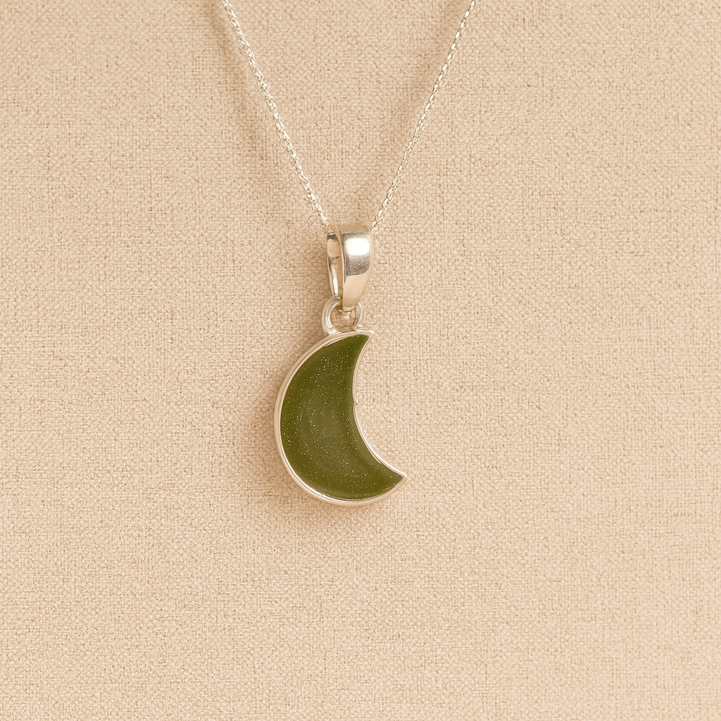 Silver Moon memorial Necklace with sage resin, filled with ashes or fur, displayed on a soft beige background – suitable for pet or human memorials.