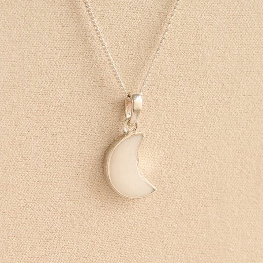 Silver Moon memorial Necklace with white resin, filled with ashes or fur, displayed on a soft beige background – suitable for pet or human memorials.