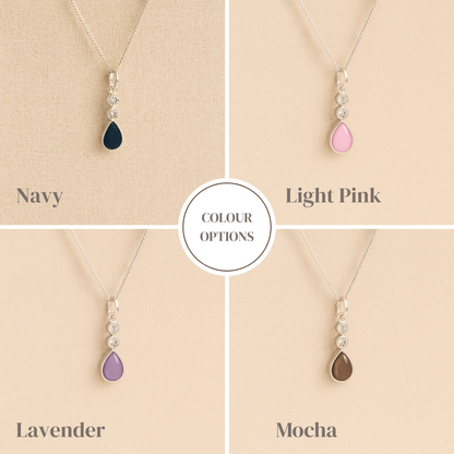 Teardrop-shaped ashes necklaces with color options on a beige background