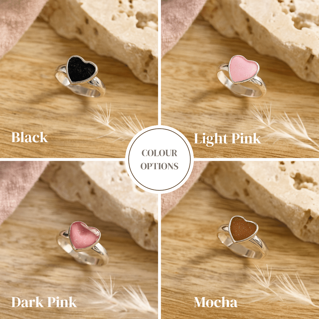 Heart-shaped ashes rings in black, light pink, dark pink, and mocha colors on a wooden background.
