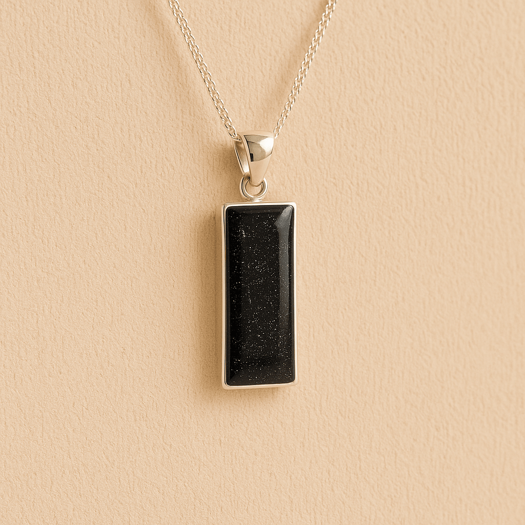 Men’s Cremation Ashes Rectangle Necklace with black resin on a beige background