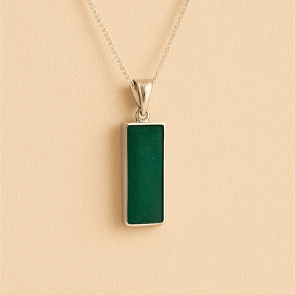 Men’s Cremation Ashes Rectangle Necklace with dark green resin on a beige background
