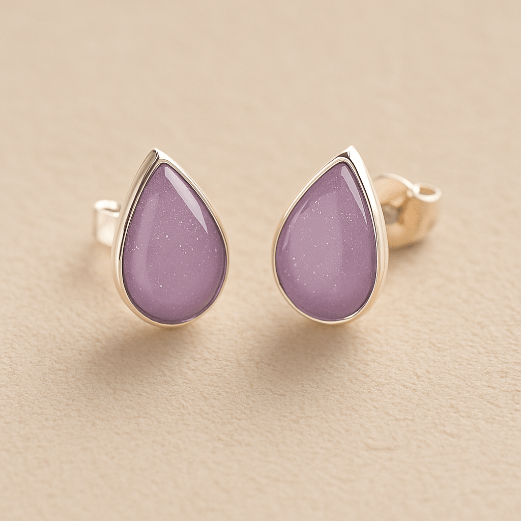 Cremation Ashes Teardrop Earrings with lavender resin on a beige background