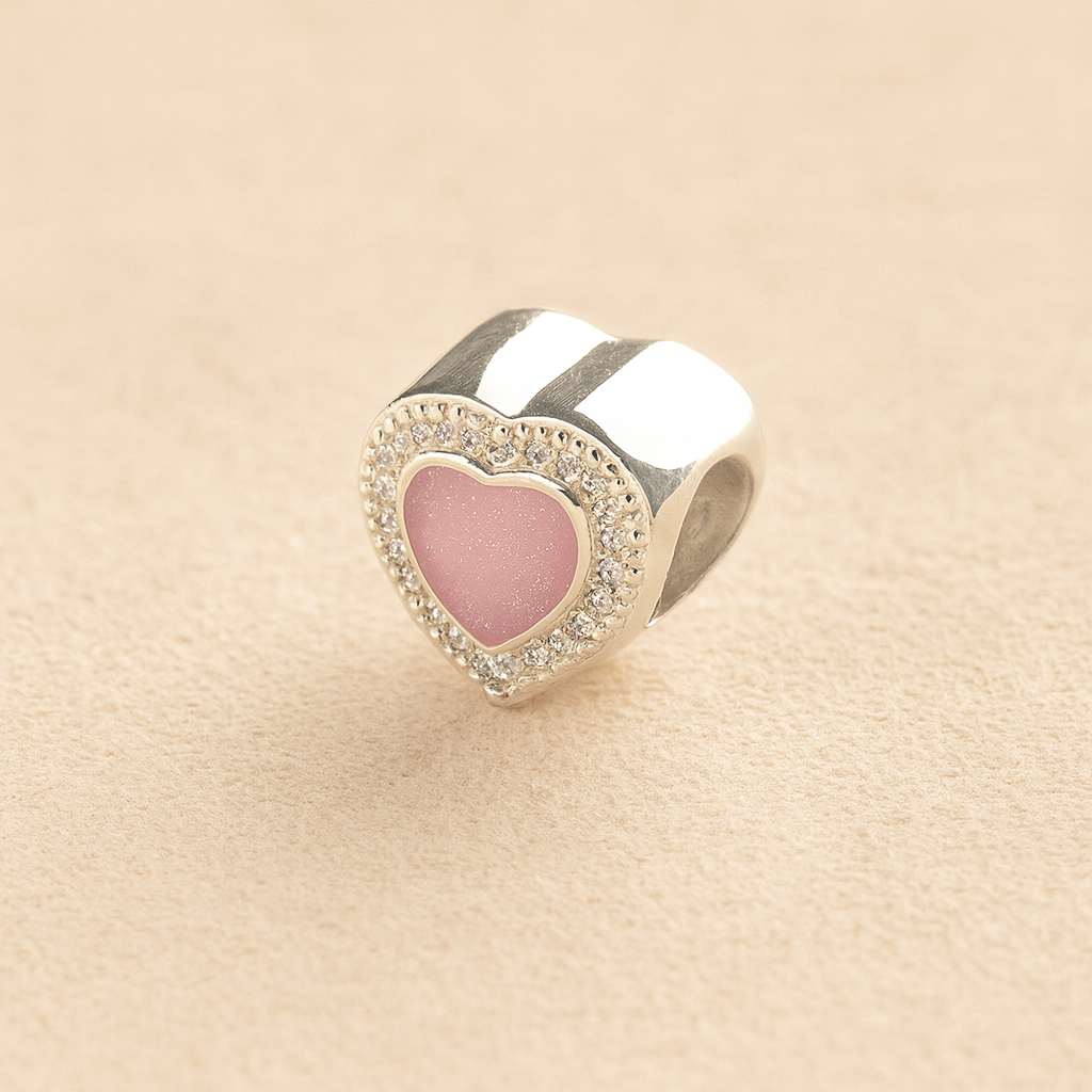 Heart-shaped silver Pandora ashes charm with a lavender resin center and CZ border on a beige background